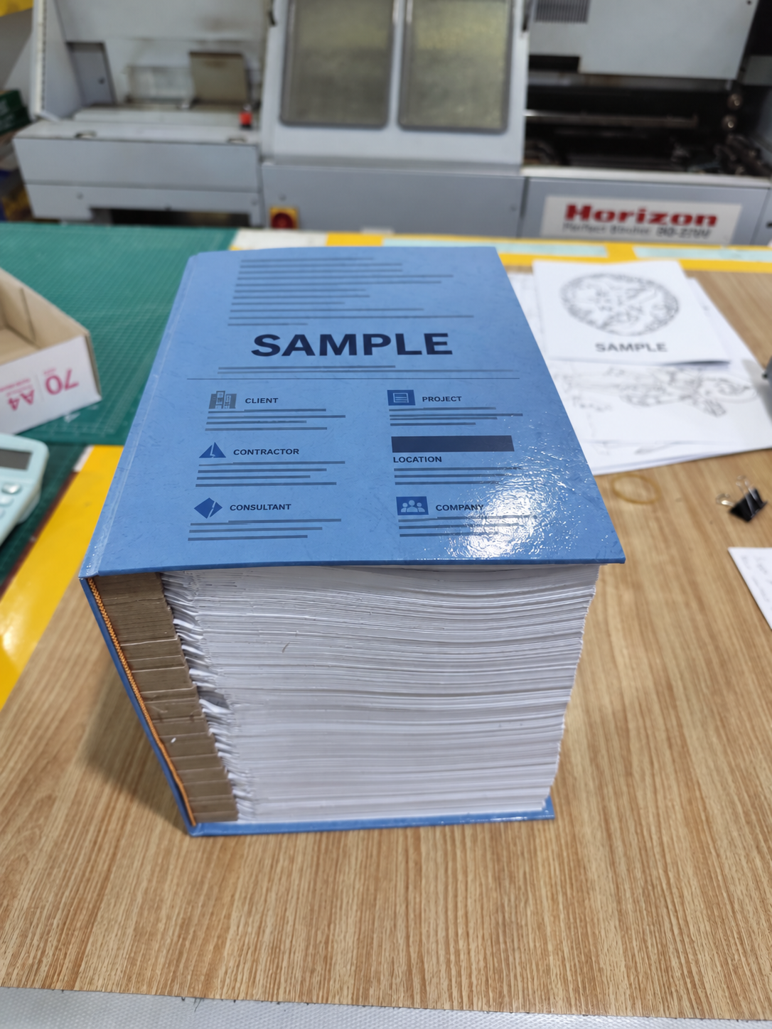 Blue sample hardcover with folded drawings